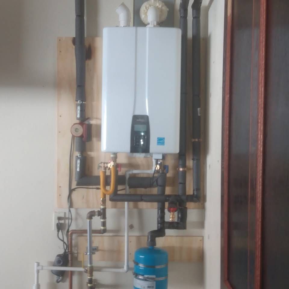 A white water heater is mounted to a wall