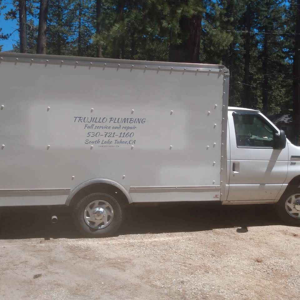 A white truck with the word plumbing on the side