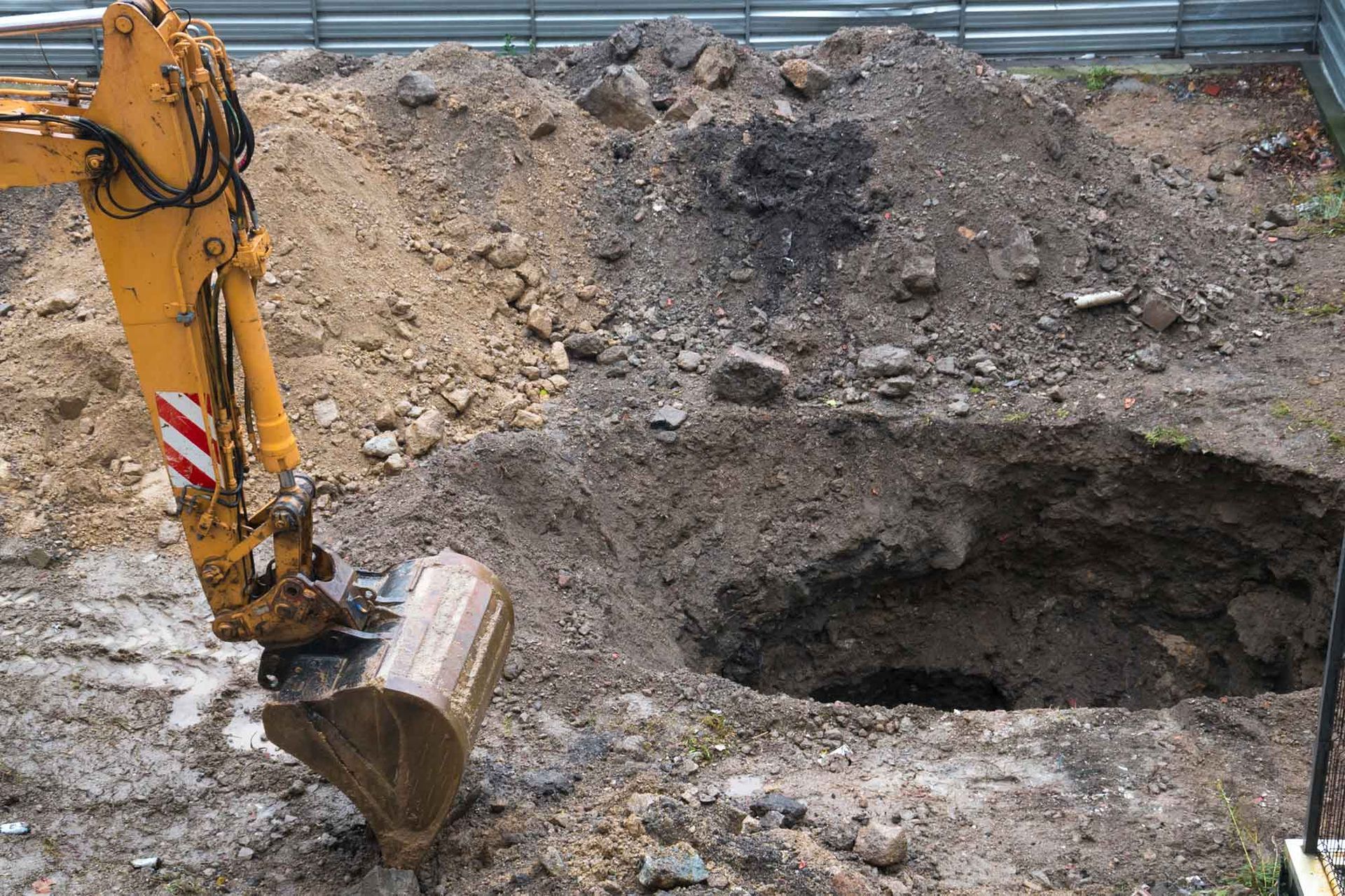 Excavator digging at a construction site, providing eco-friendly excavation services in Mount Kisco,