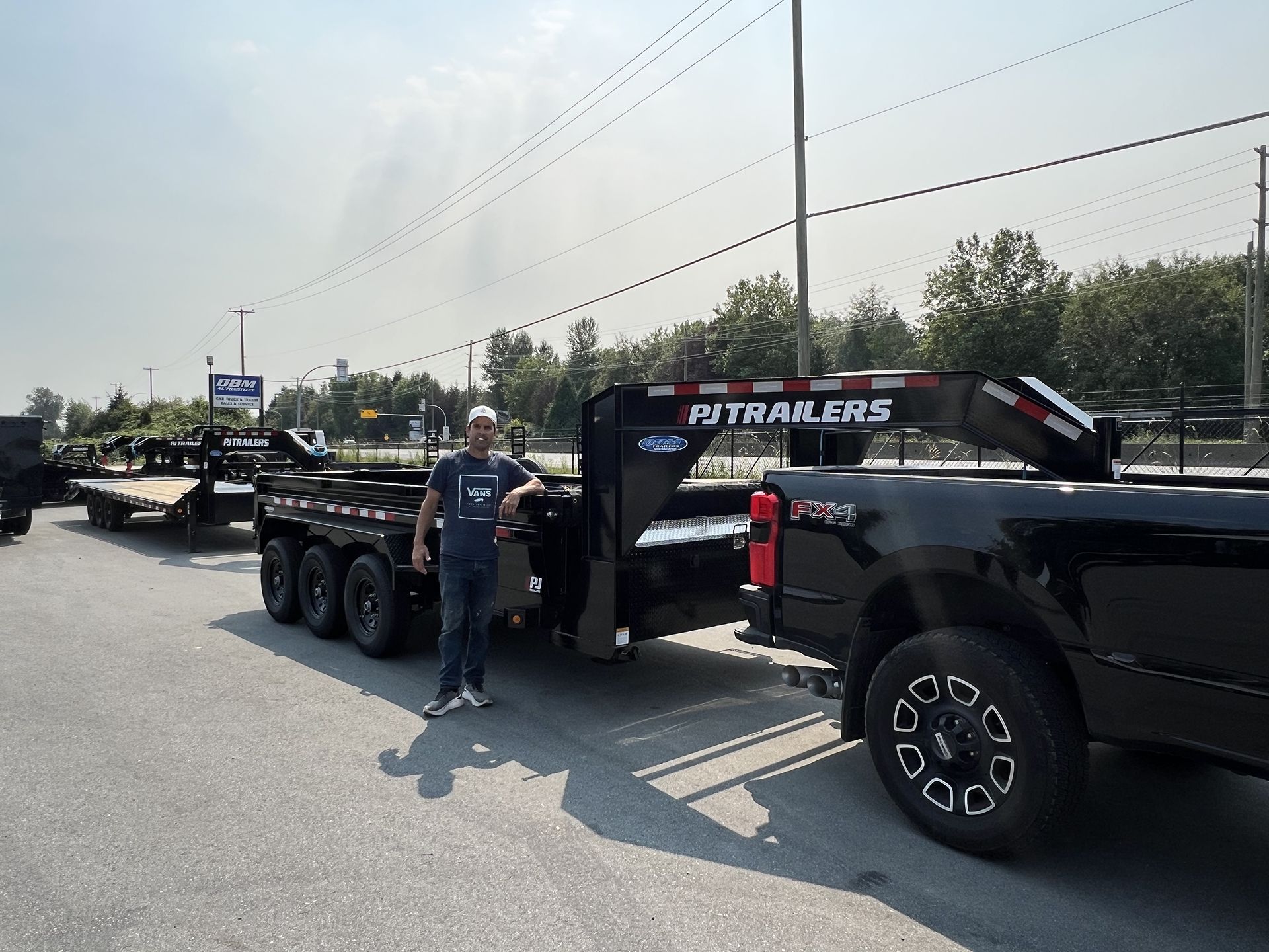 A Man Posing Next to Black Pickup Truck Trailer in Pitt Meadows, BC - DBM Automotive