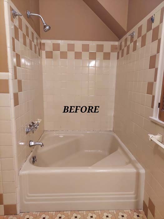 A beige and brown tiled bathroom with a tub. 