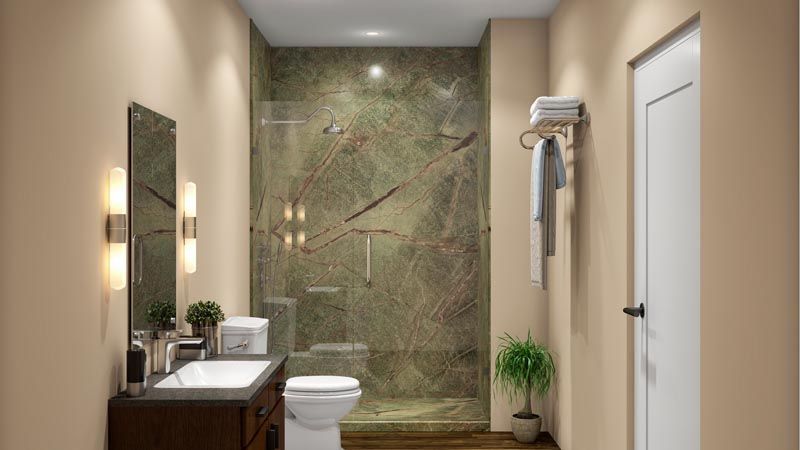 Bathroom with green marble shower, white toilet, and dark wood vanity. Beige walls and white door.