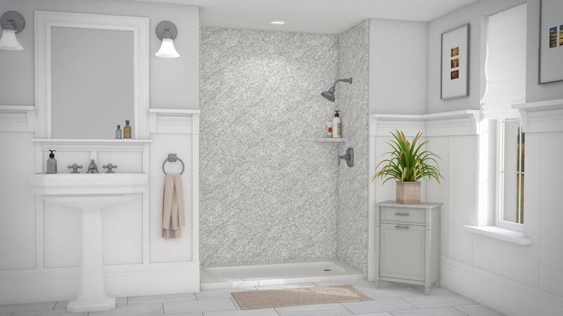 Bathroom with white walls, a textured shower, and a pedestal sink.