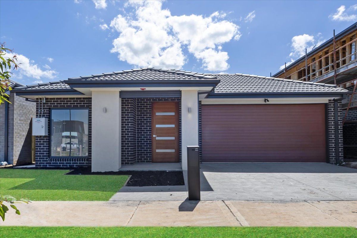 A large brick house with a gray garage door