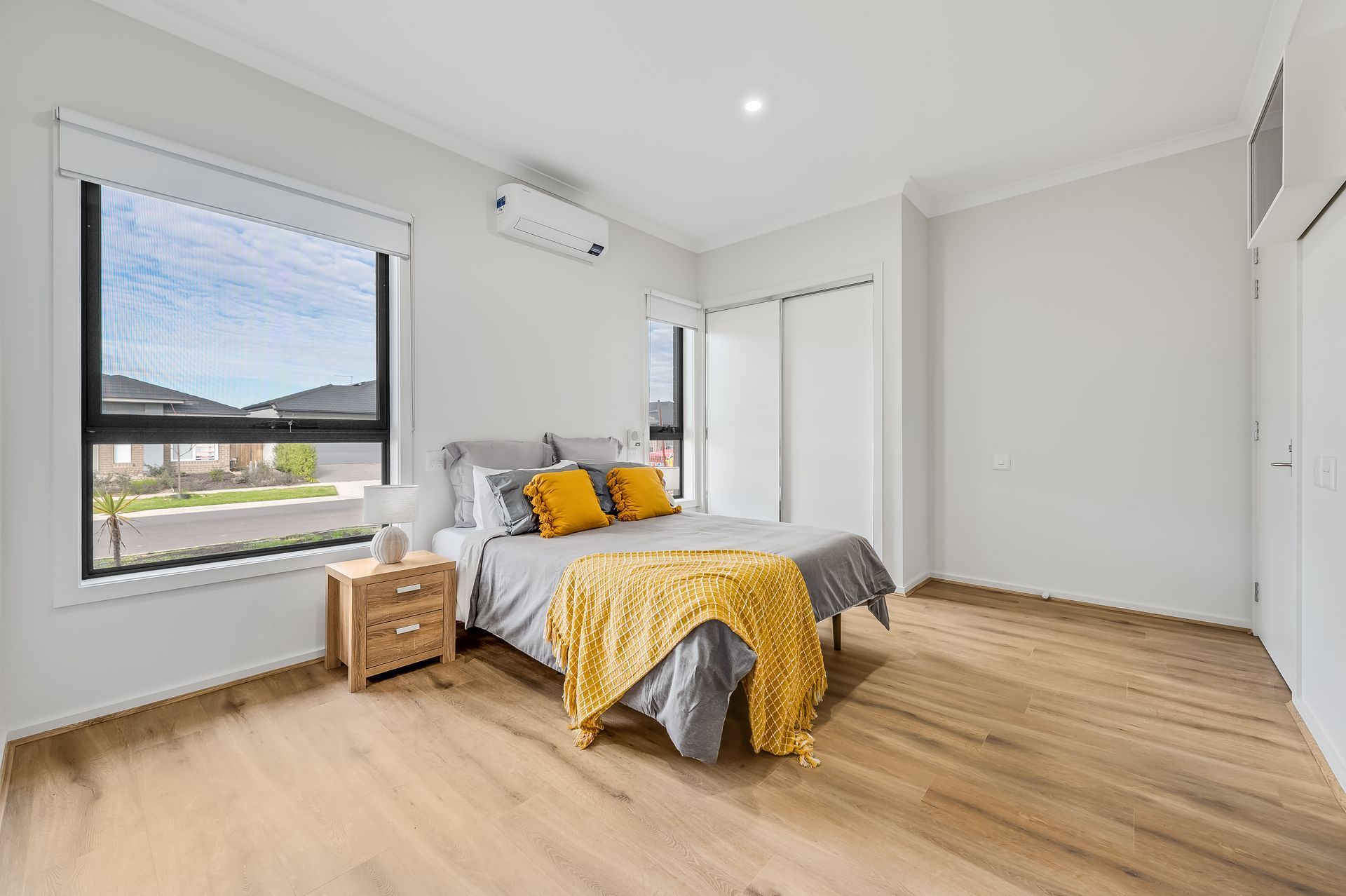 A bedroom with a bed , nightstand , and window.