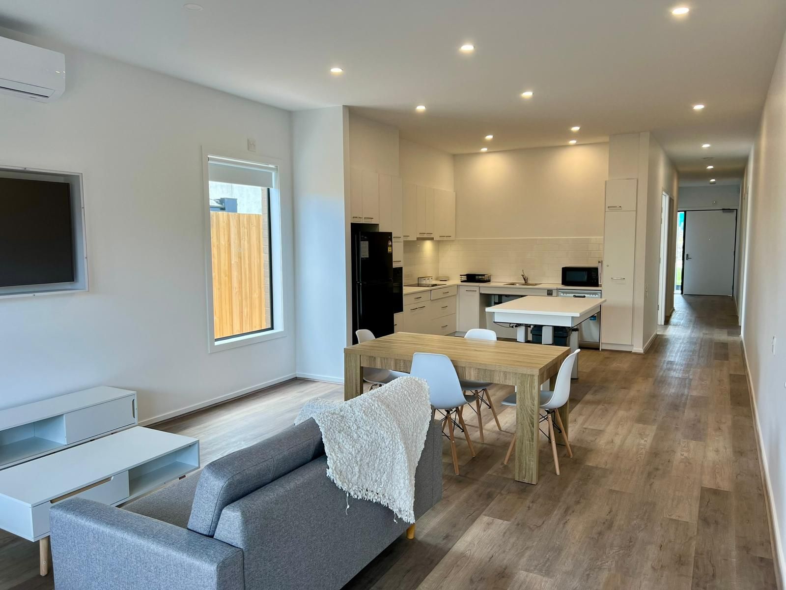 A living room with a couch , table and chairs