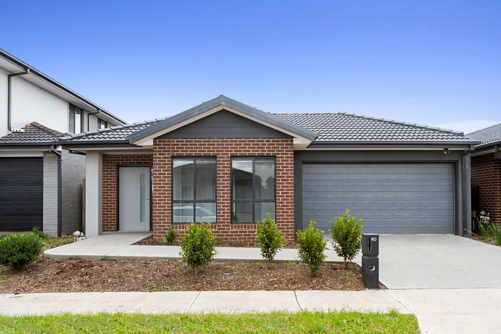 A large brick house with a gray garage door