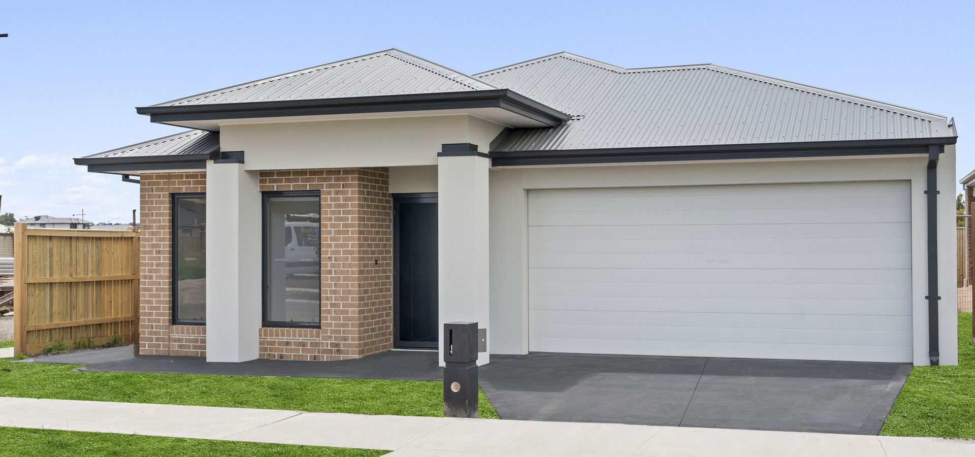 The front of a house with a driveway and a mailbox.