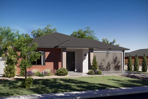 A house with a garage and a wooden fence in front of it.
