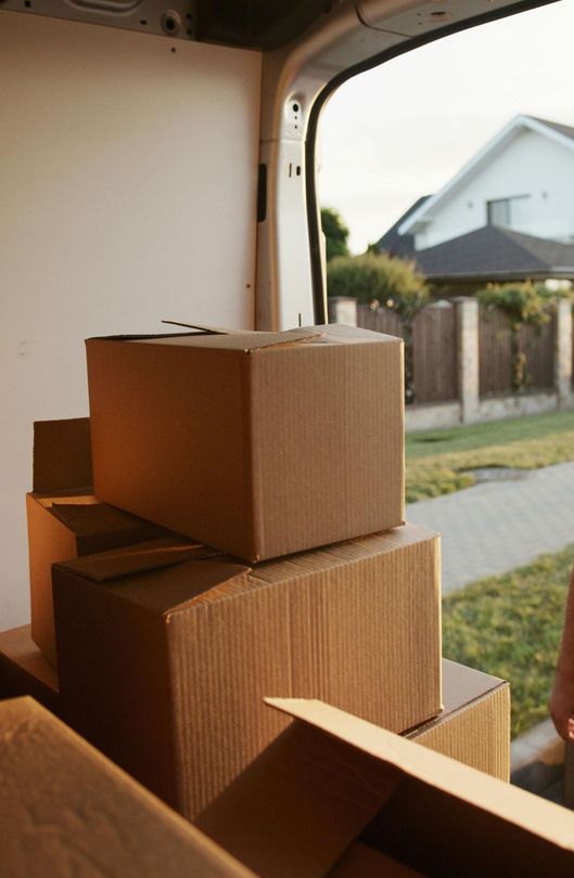 A stack of cardboard boxes in the back of a van