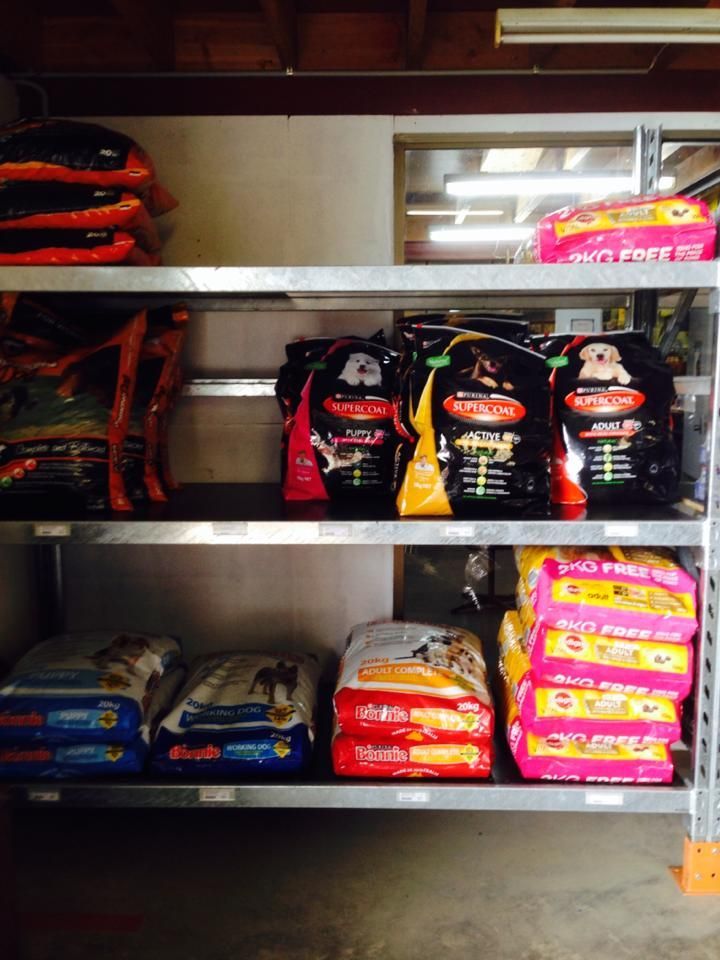 A bunch of bags of dog food are on a shelf