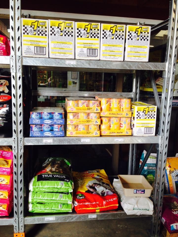 A shelf full of dog food including a bag of pedigree