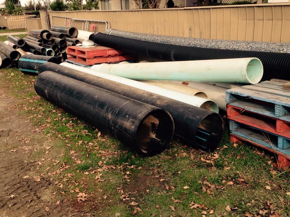 A bunch of pipes are stacked on top of each other