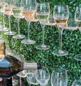 champagne being poured into glasses on a champagne wall at Fizz Sacramento Champagne & Bubbles Bar.