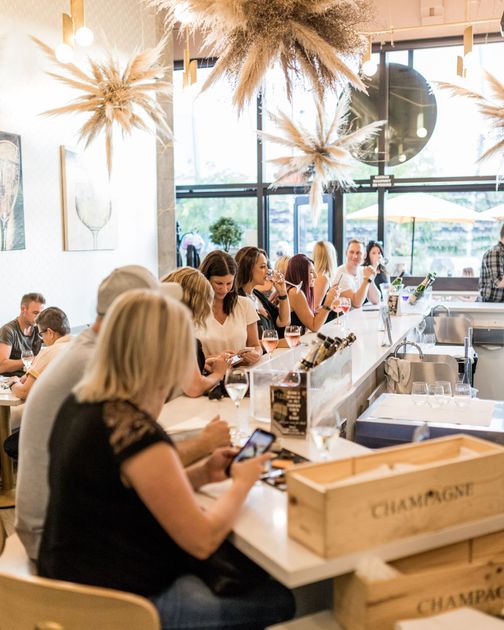 Customers enjoying champagne at the bar counter.