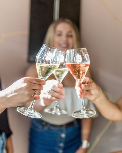 Customers cheersing glasses of champagne.
