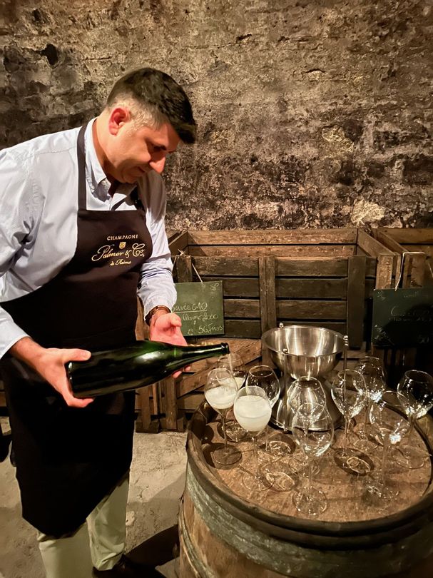 Champagne being poured in a cellar in Champagne, France.