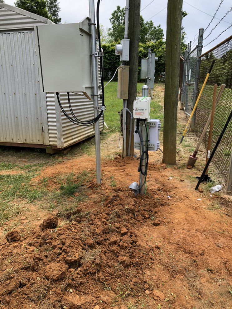 There is a shed in the background and a pile of dirt in the foreground.