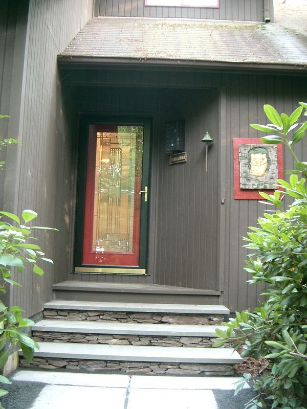 The front door of a house with a red door