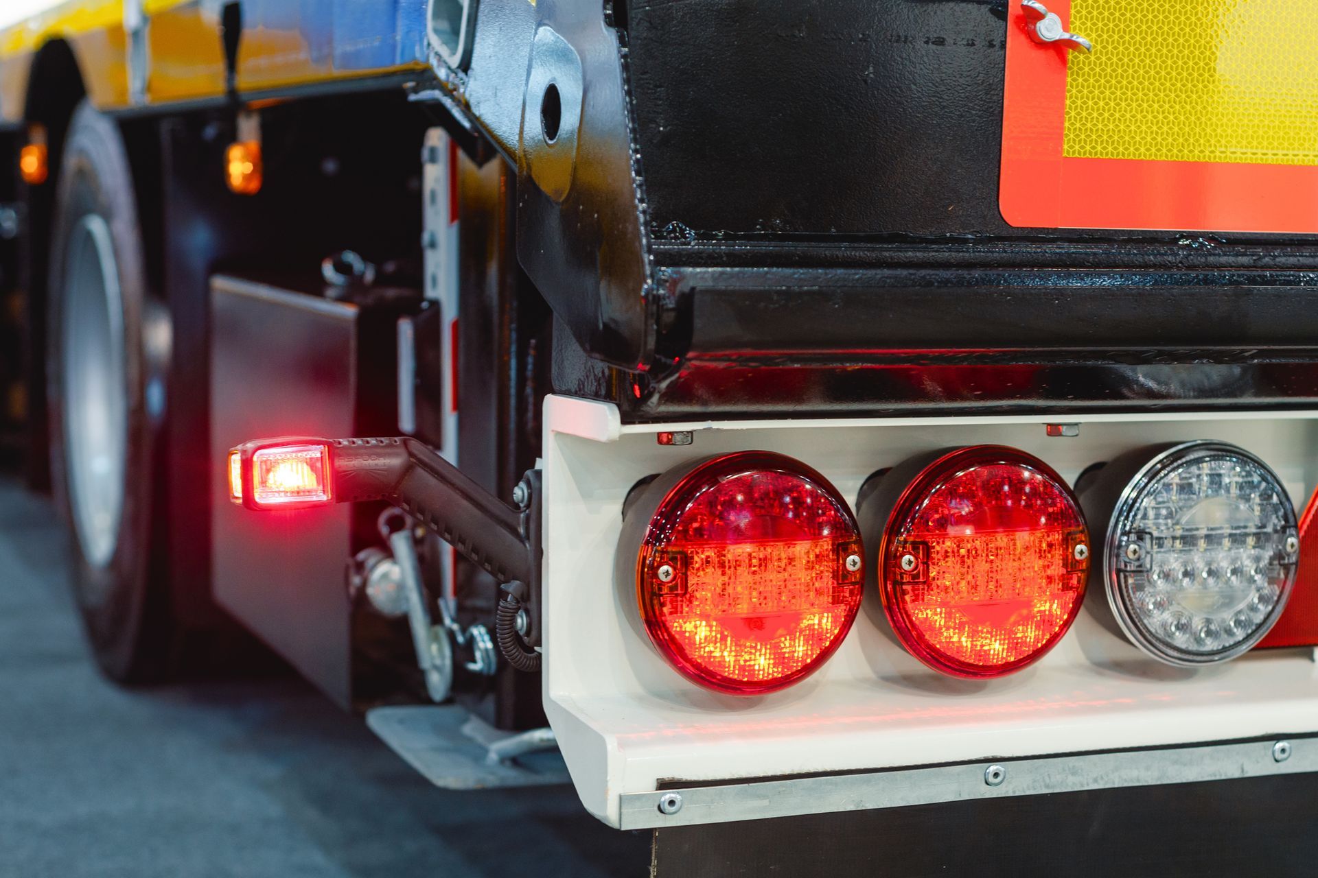 The back of a truck with red lights on it.
