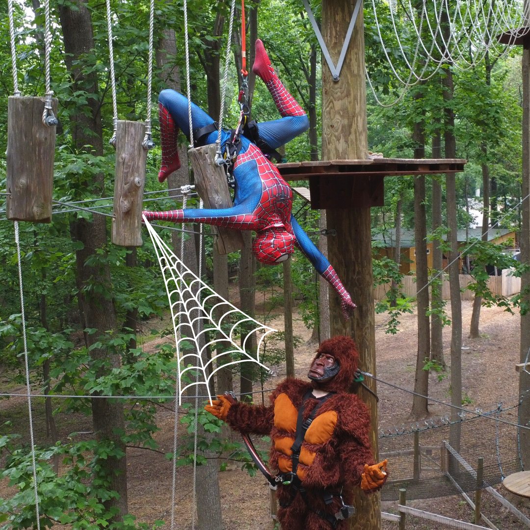 Spiderman and Bigfoot climbing on high ropes course