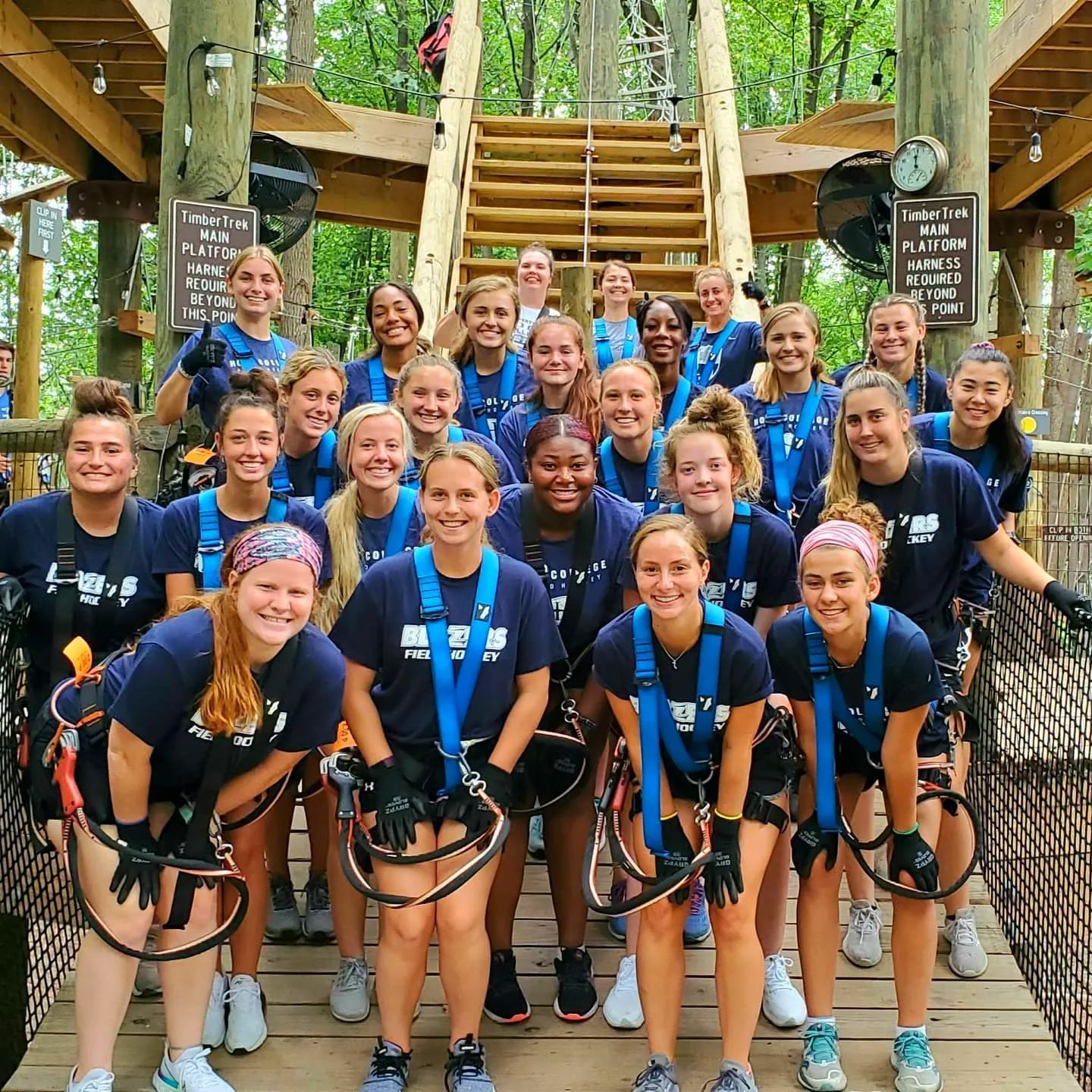 Girls sports team bonding at ropes course