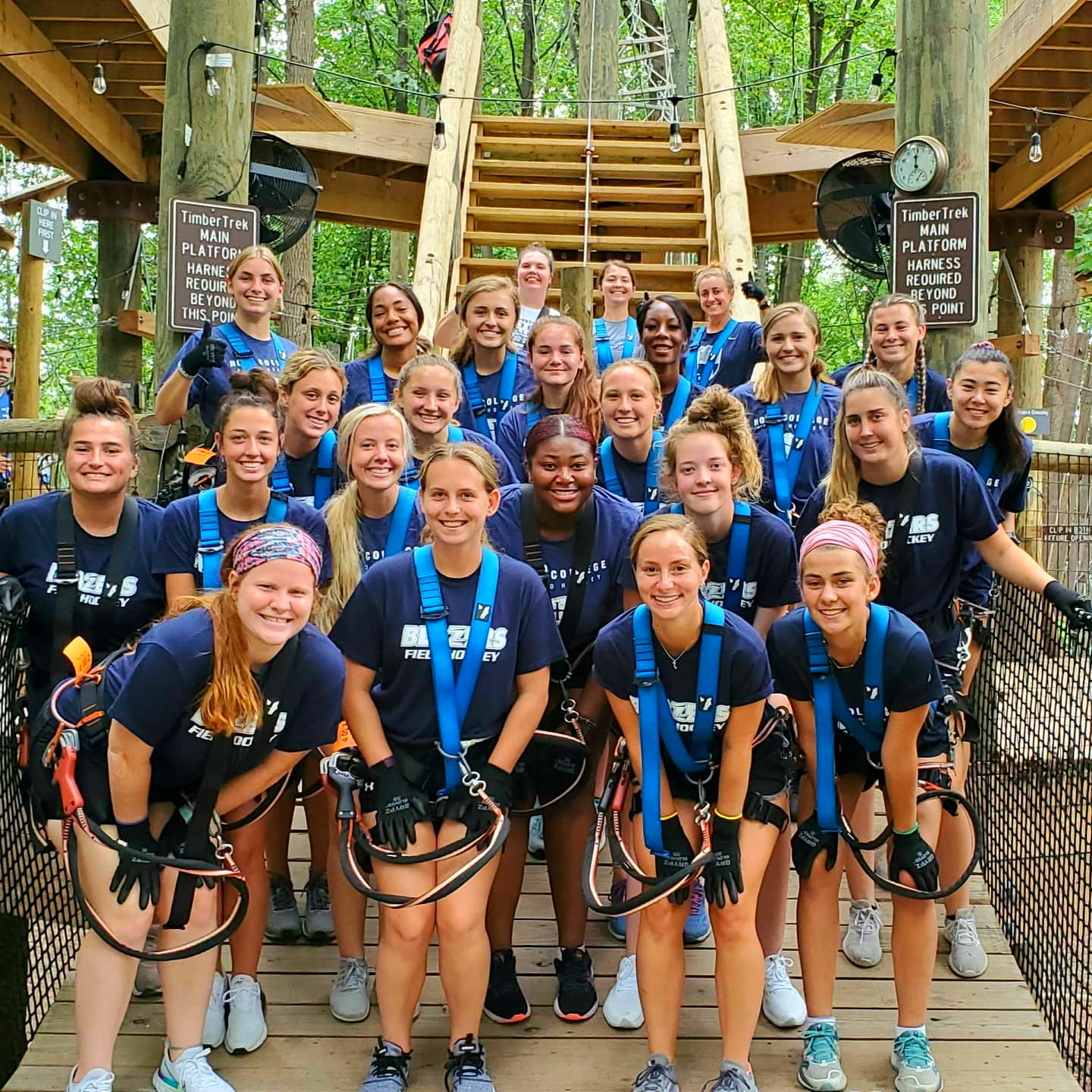 Team sports group participating in team bonding on ropes course