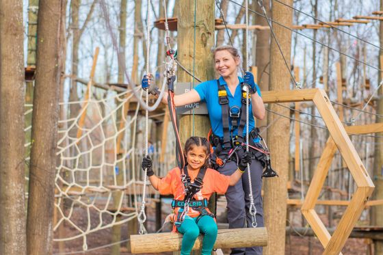 Adult female climbing with young girl