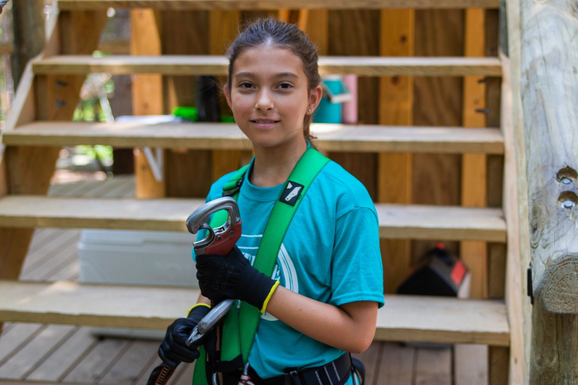 Young camper standing on the main platform of Timber Trek ropes course