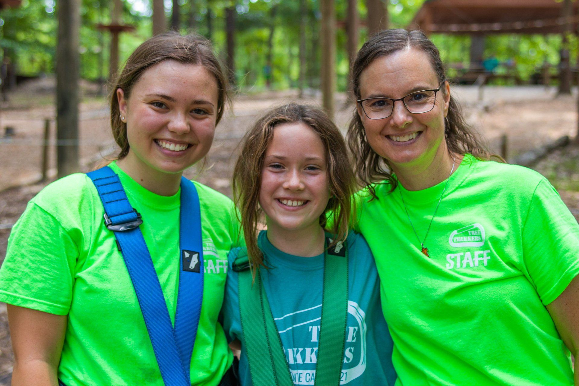 Female camp counselors with camper at summer camp