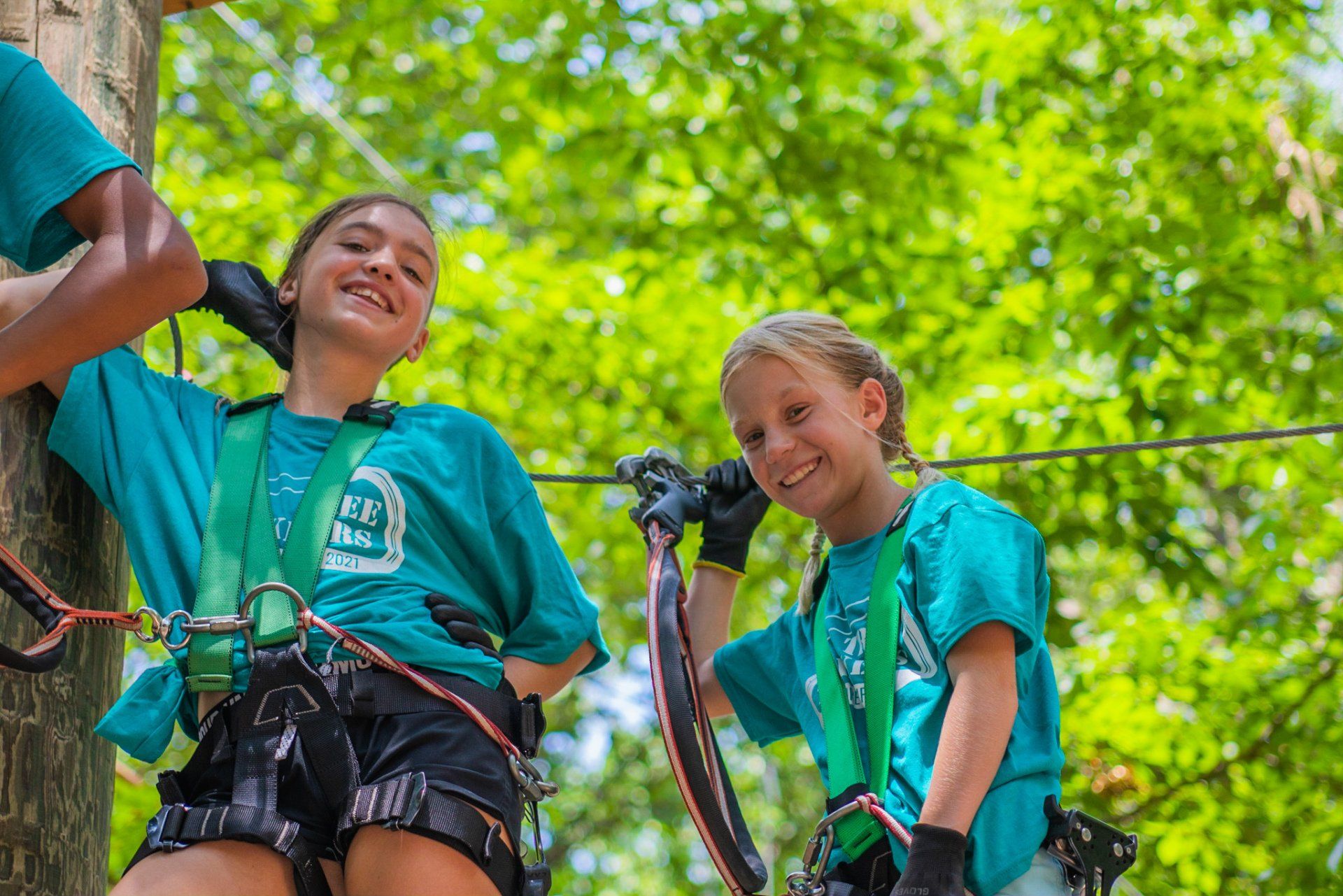 2 young girls climbing on ropes course during summer camp
