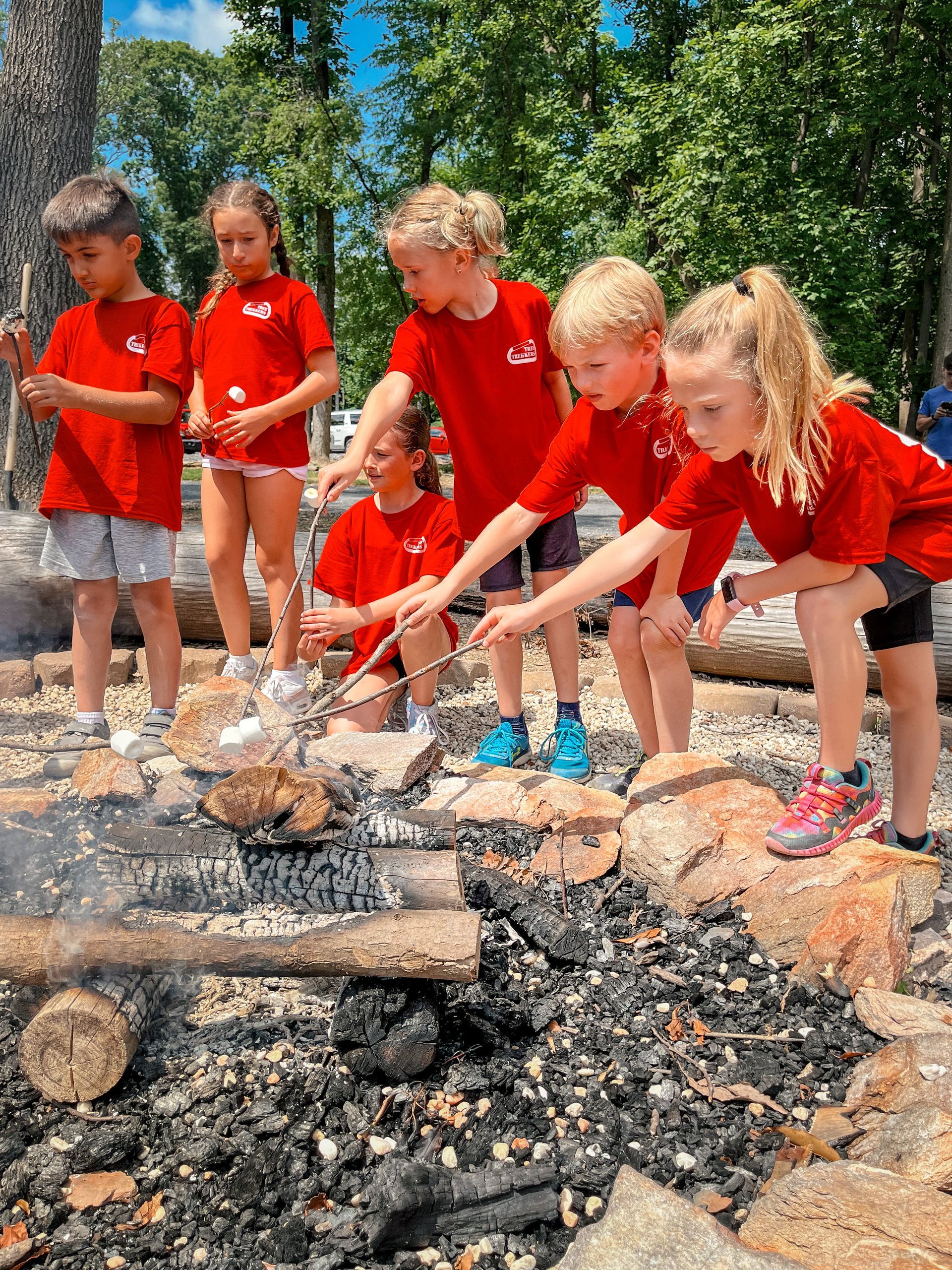 Campers roasting marshmallows at Summer Adventure Camp