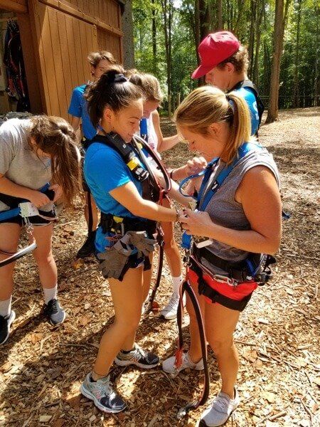 staff harnessing a customer at Tree Trekkers