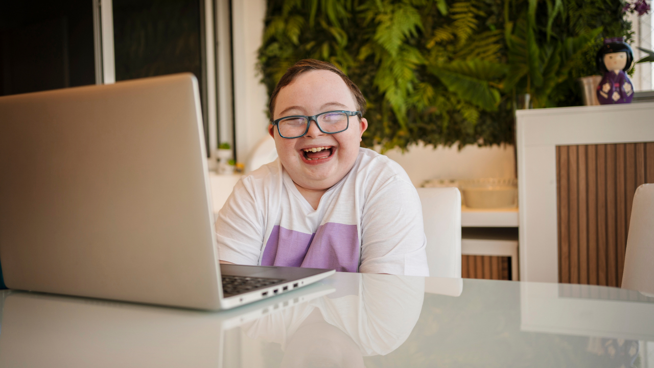 Happy child with Down syndrome learning at home through ABA therapy for homeschool families with Positive Reinforcement PLLC