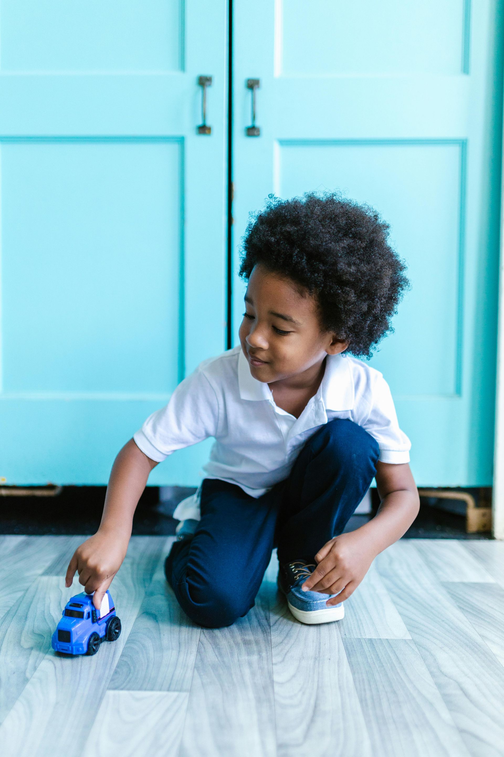 Boy playing with car - ABA Therapy