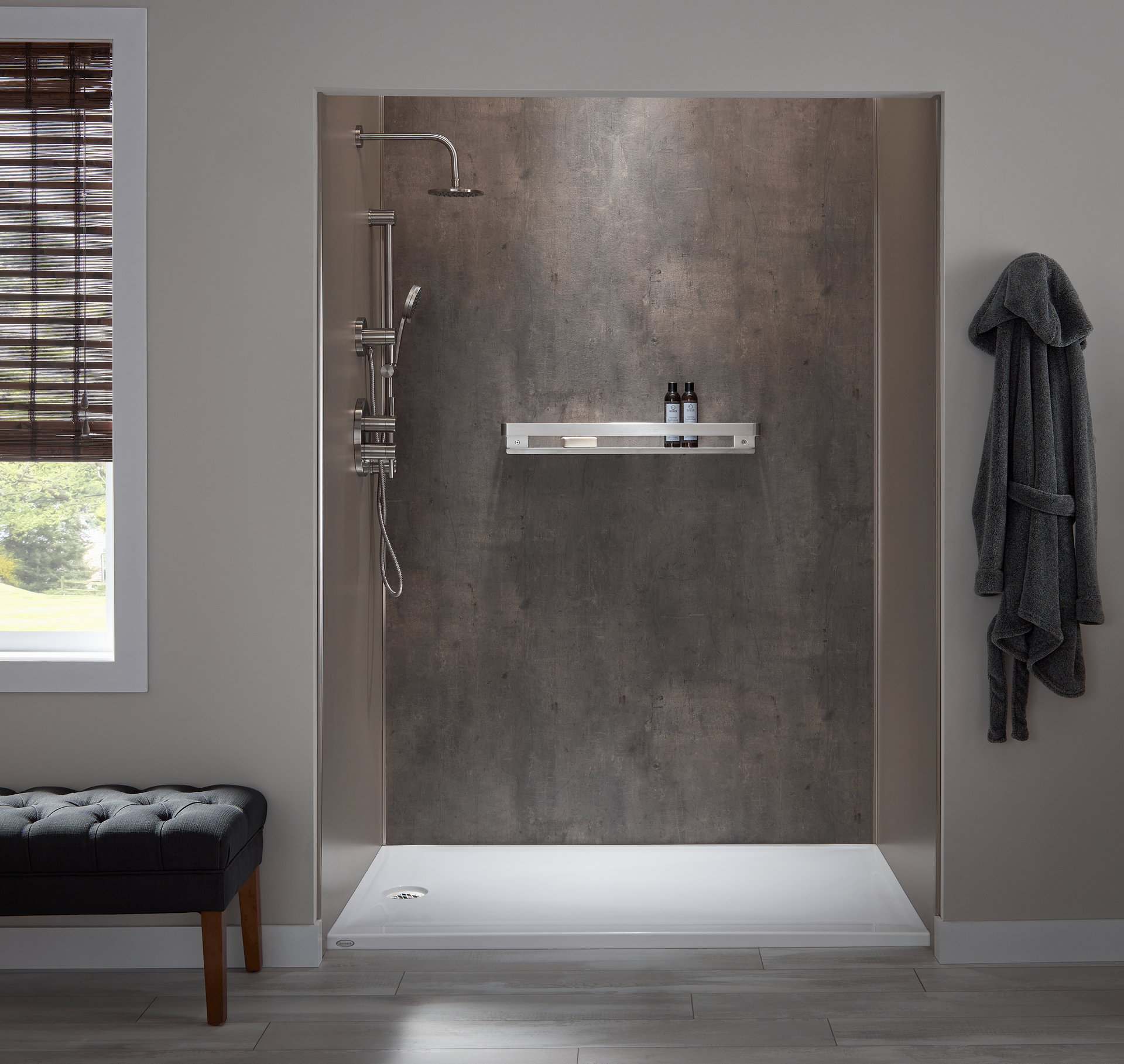 A bathroom with a walk in shower and a window.