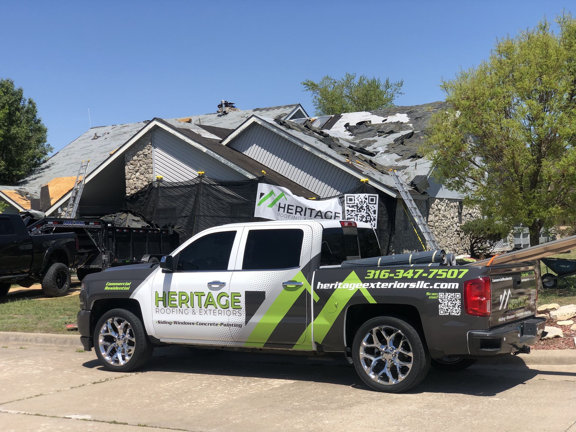 A heritage truck is parked in front of a damaged house.