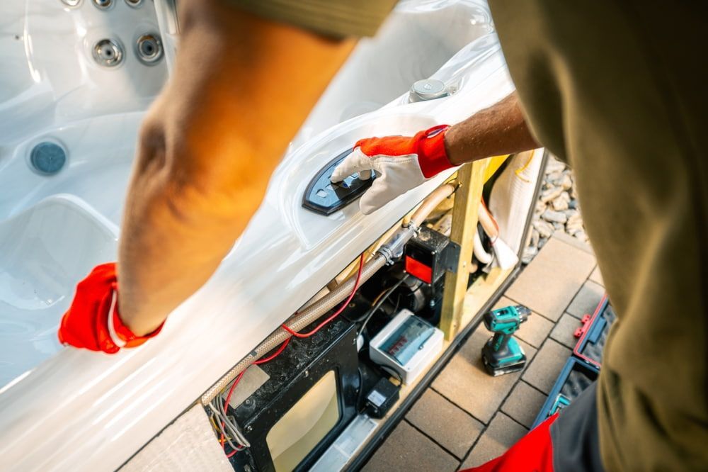Person in red gloves repairing a hot tub
