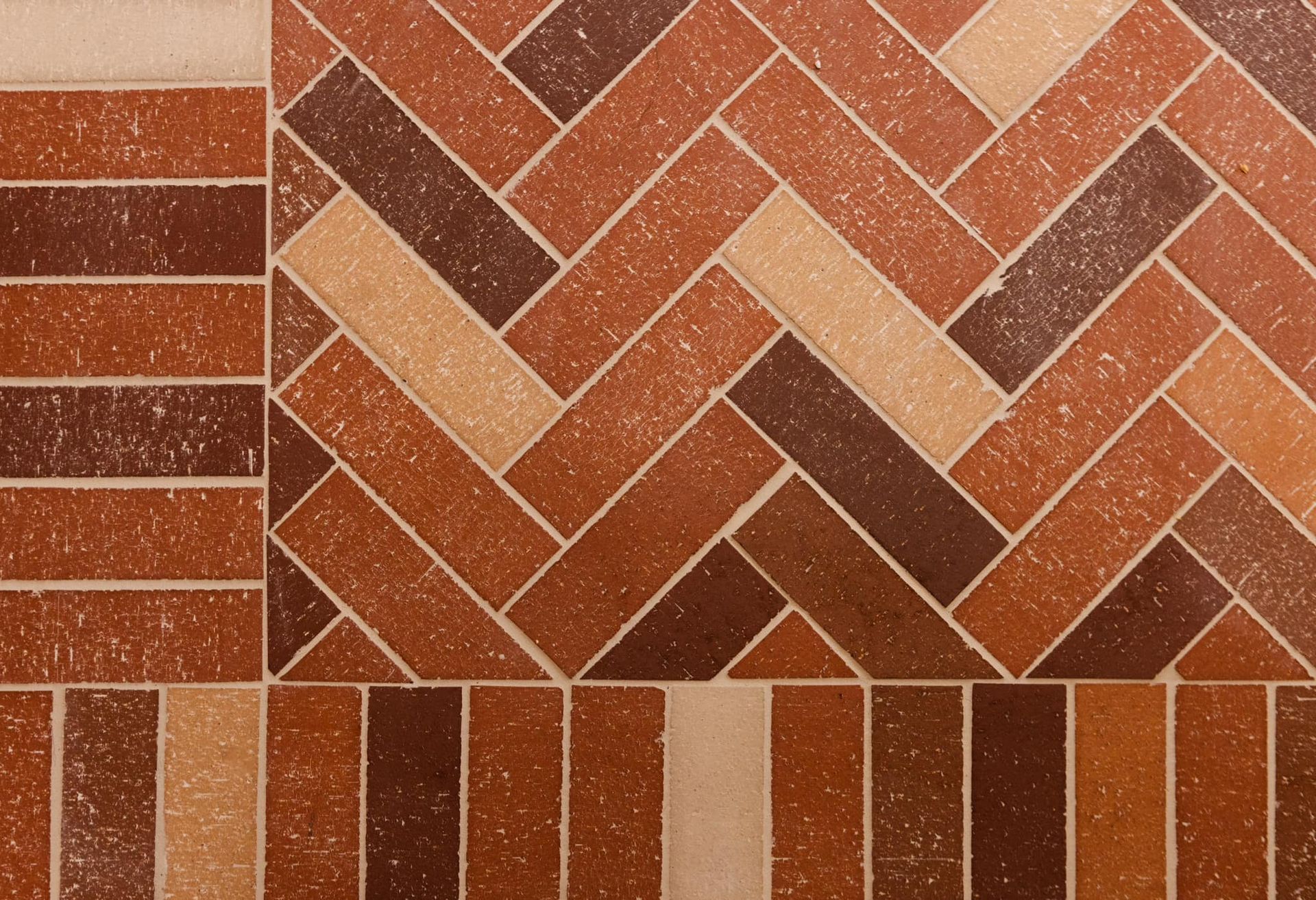 A close up of a brick floor with a herringbone pattern