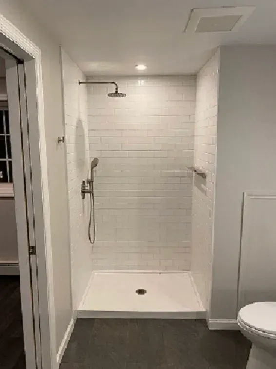 A Bathroom With A Walk In Shower And A Toilet — Rhinebeck Painters & Carpenters LLC