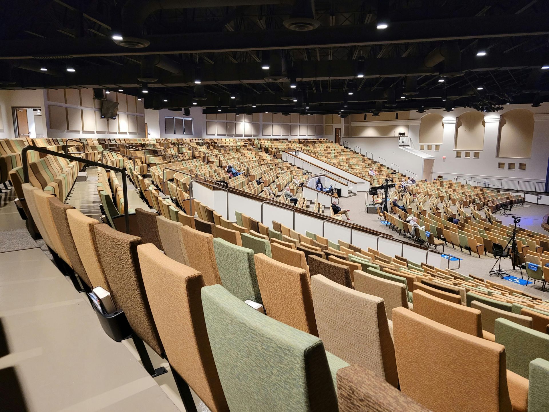 A large auditorium filled with rows of chairs.