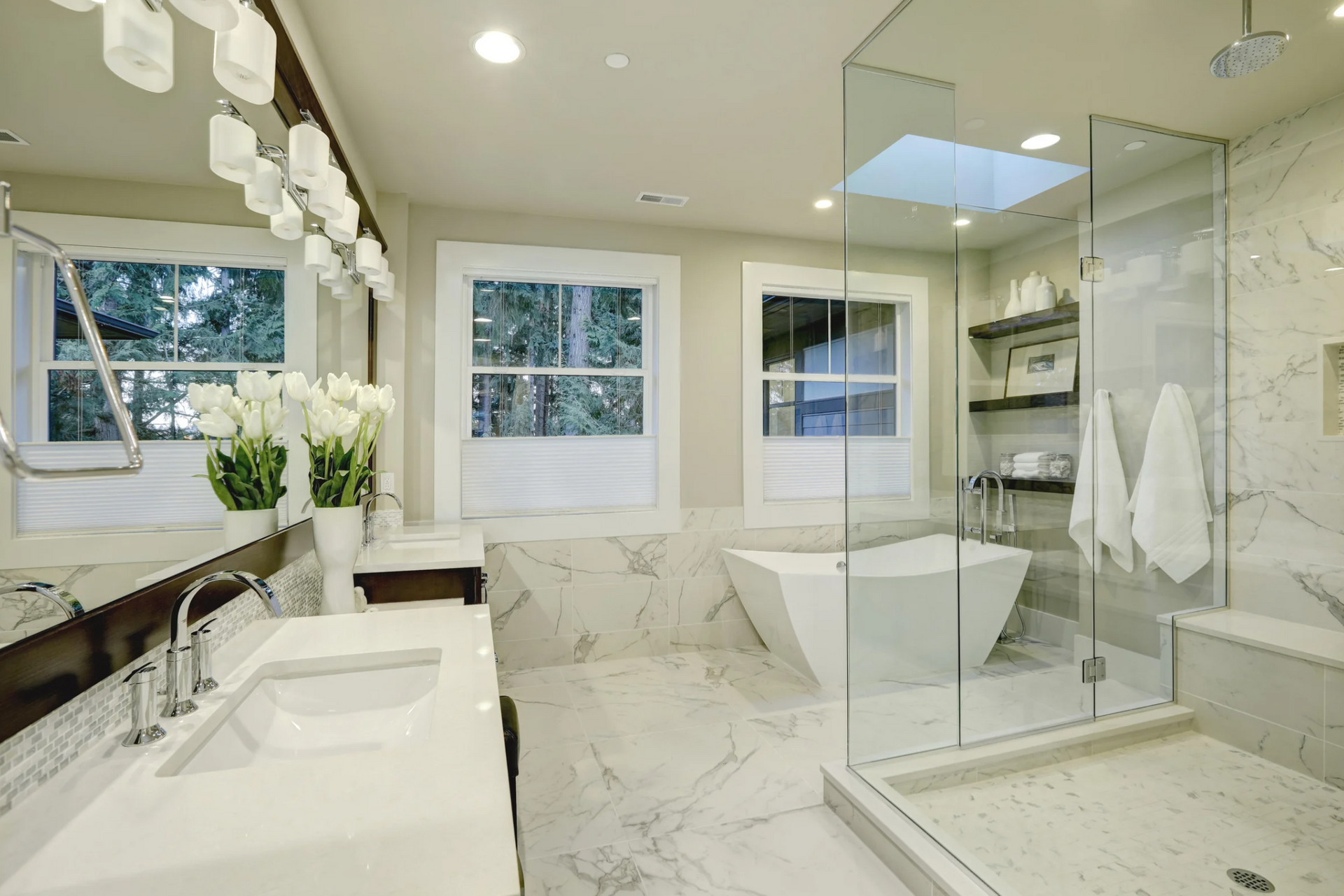 A bathroom with two sinks , a tub , and a walk in shower.