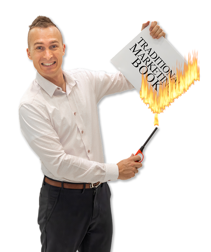 Andy holding a book on fire with the words Traditional Marketing Book while holding a lighter
