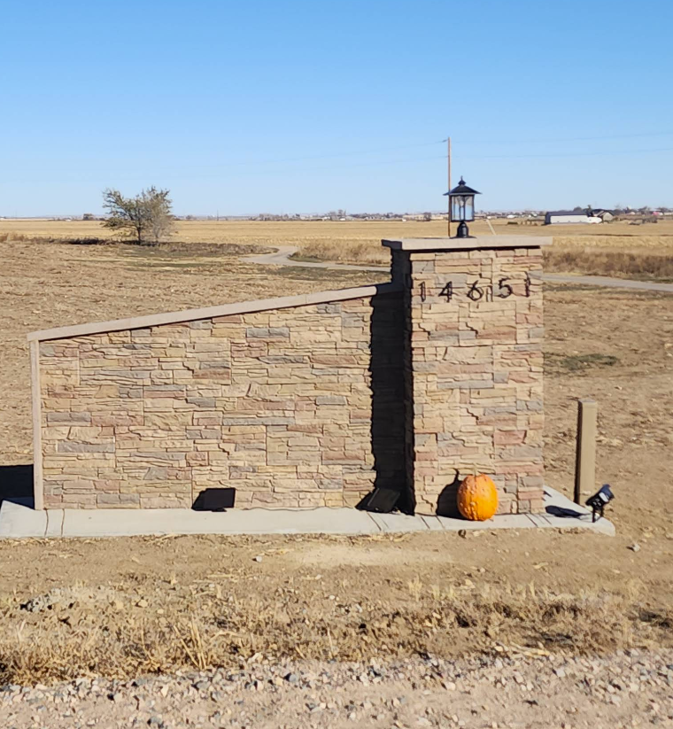 A stone monument with the address 