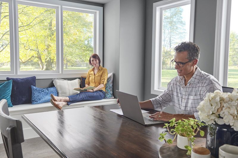 A couple seated inside their home.