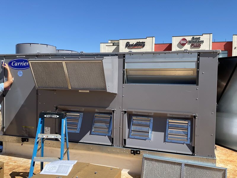 Speir Heating and Air installing a large Carrier commercial HVAC unit.
