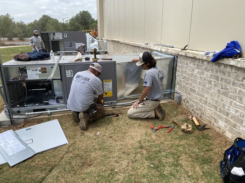 Speir technicians servicing an HVAC unit.
