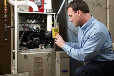 A man maintains an air conditioner.