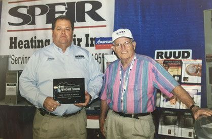 Two men receive an award.