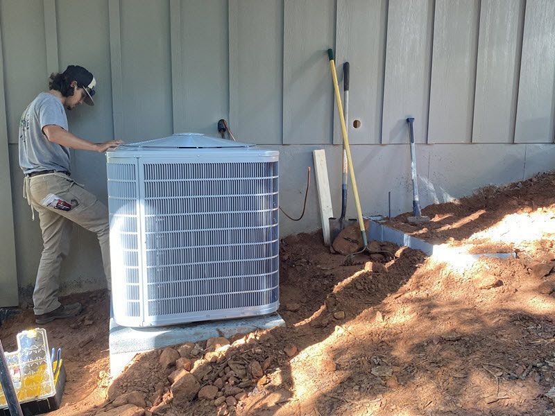 Spear air conditioner technician installs a new AC unit.